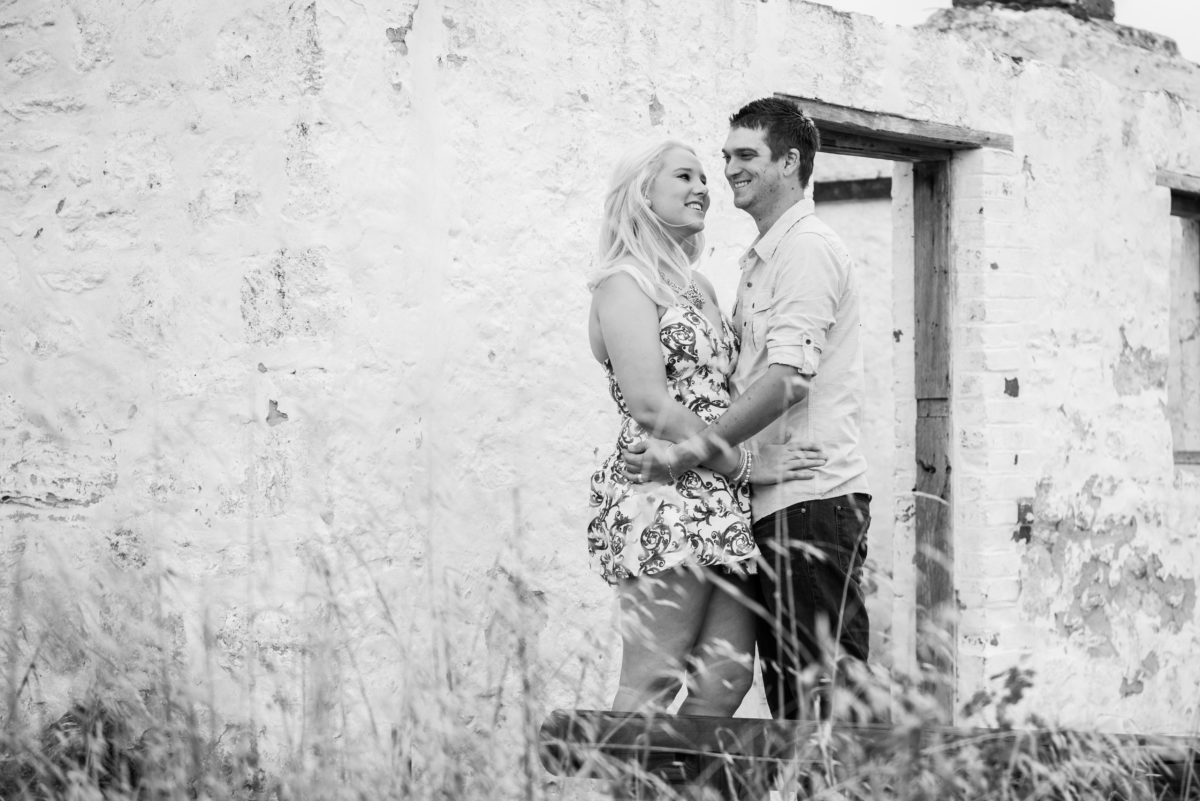 Black and white photo of engaged couple at the white hut in Yellagonga park