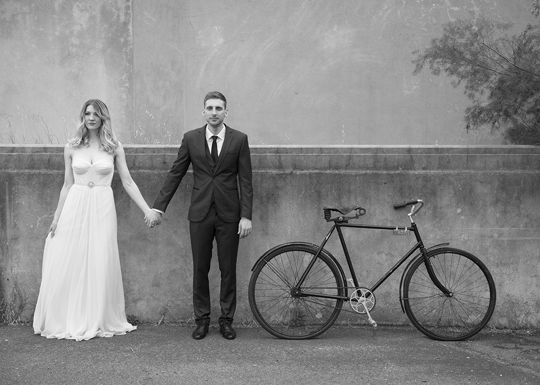 Bride and groom with vintage bicycle