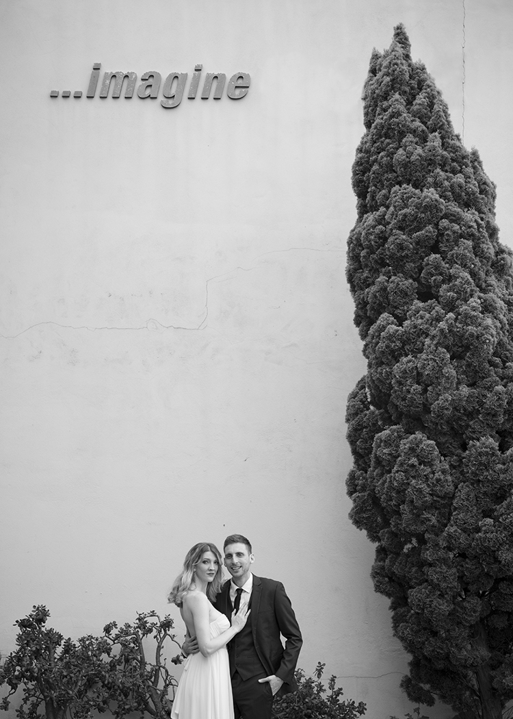 bride and groom with imagine sign