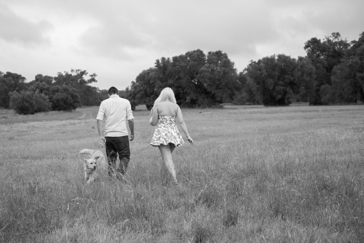 Black and white engagement shoot couple walking away from camera