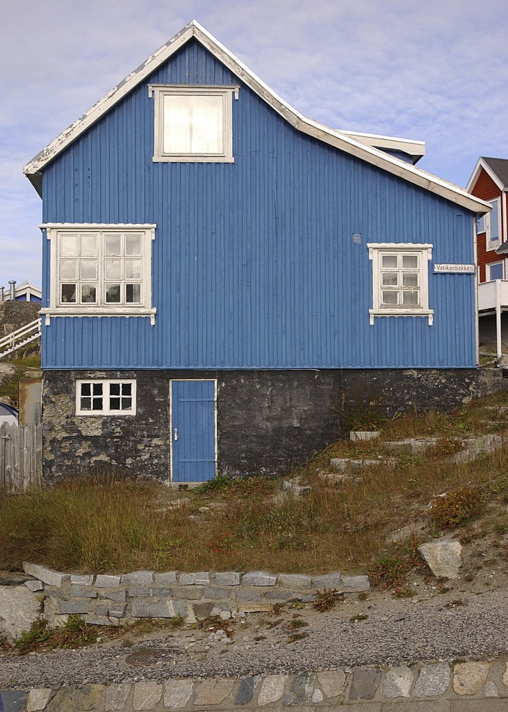 Blue wooden house in Greenland built on a stone foundation