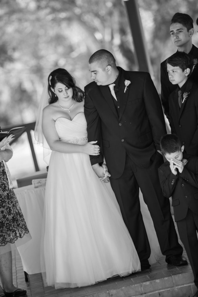 Black and white photo of wedding couple. Tender moment. Groom looking at the bride