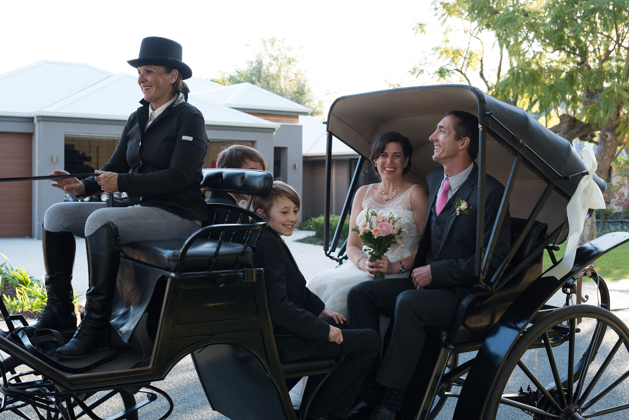 bride and groom in the back of a carriage