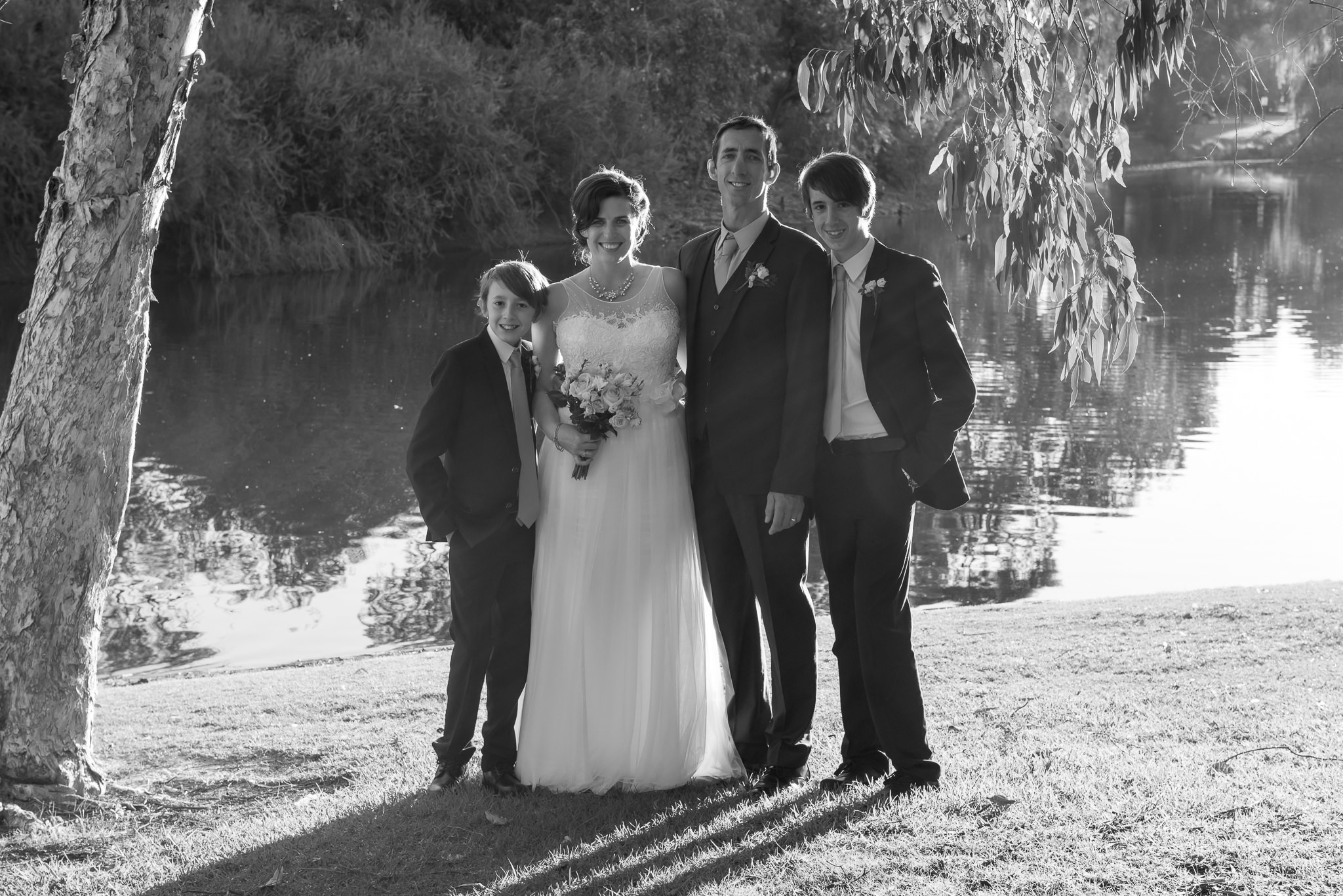 family portrait under trees by the lake