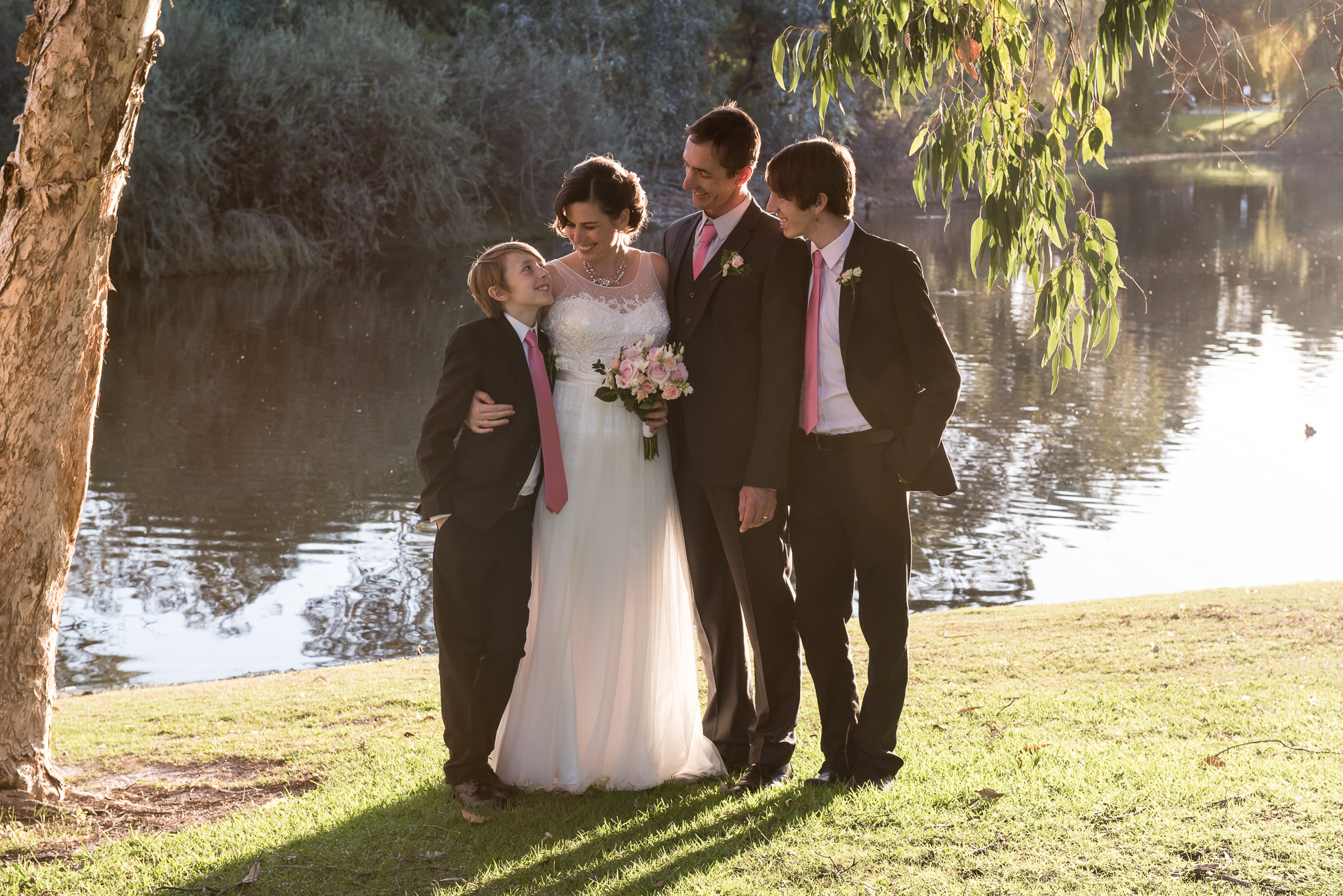 family portrait under the trees by the lake