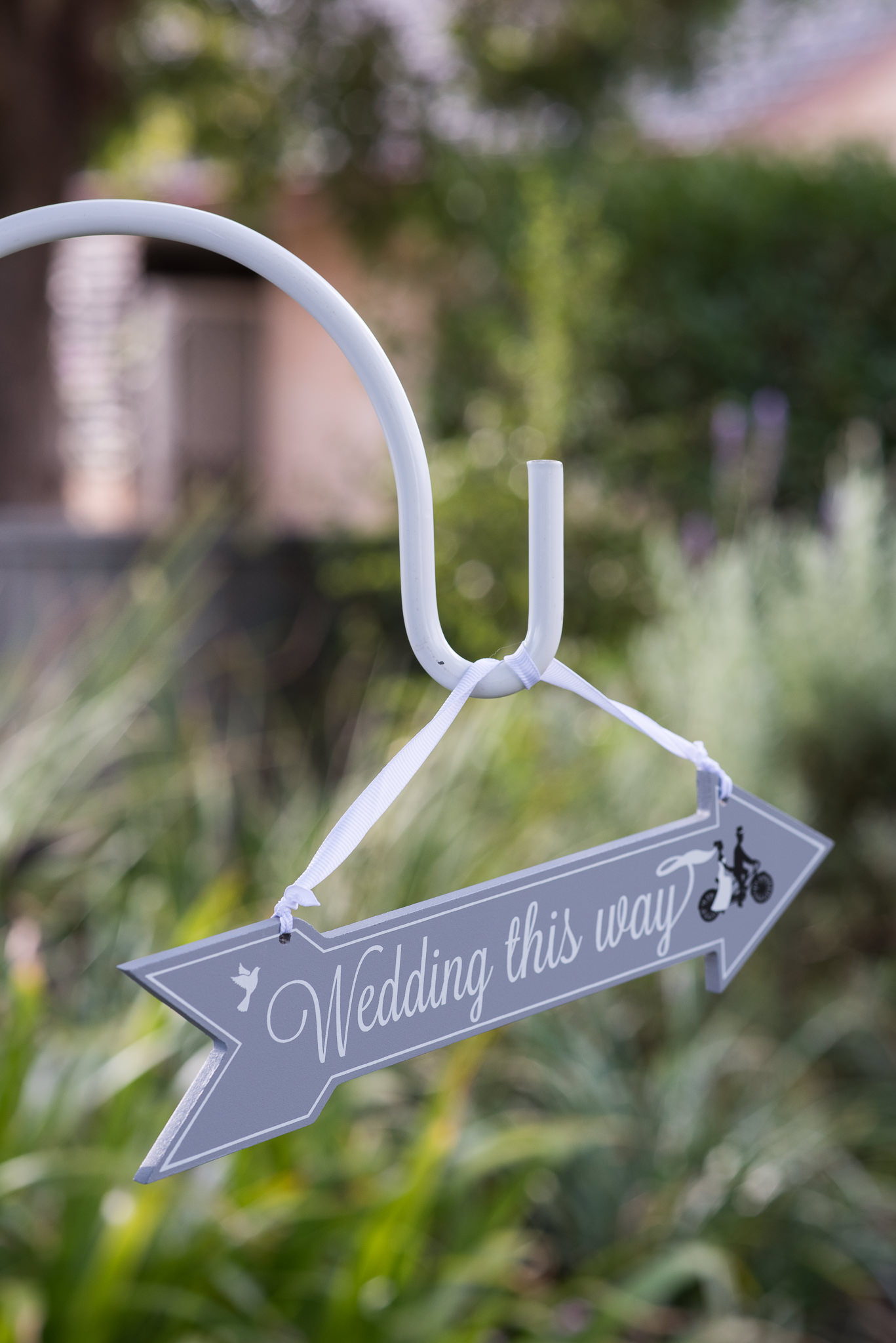 Wedding this way sign in backyard wedding garden