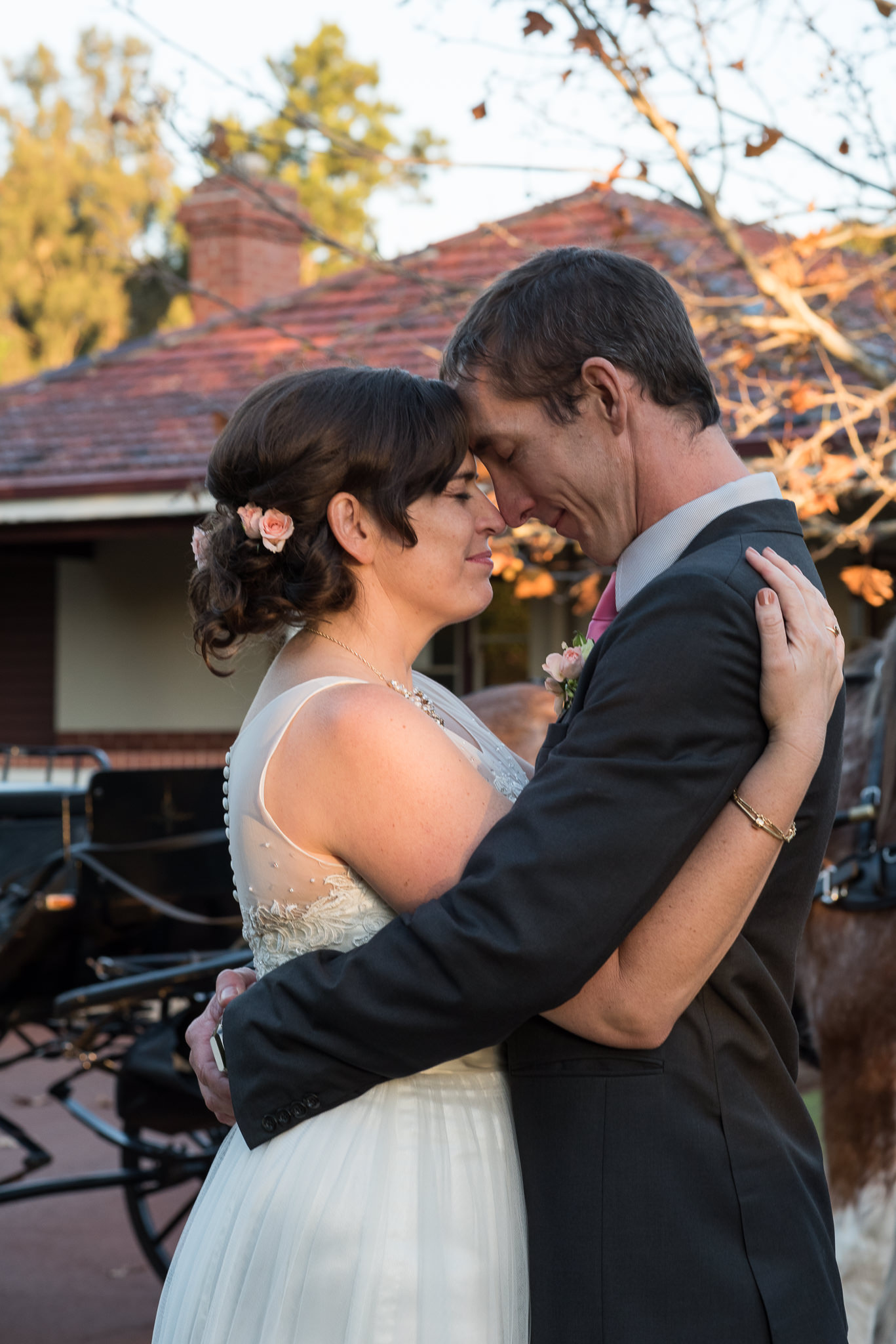 bride and groom press foreheads together