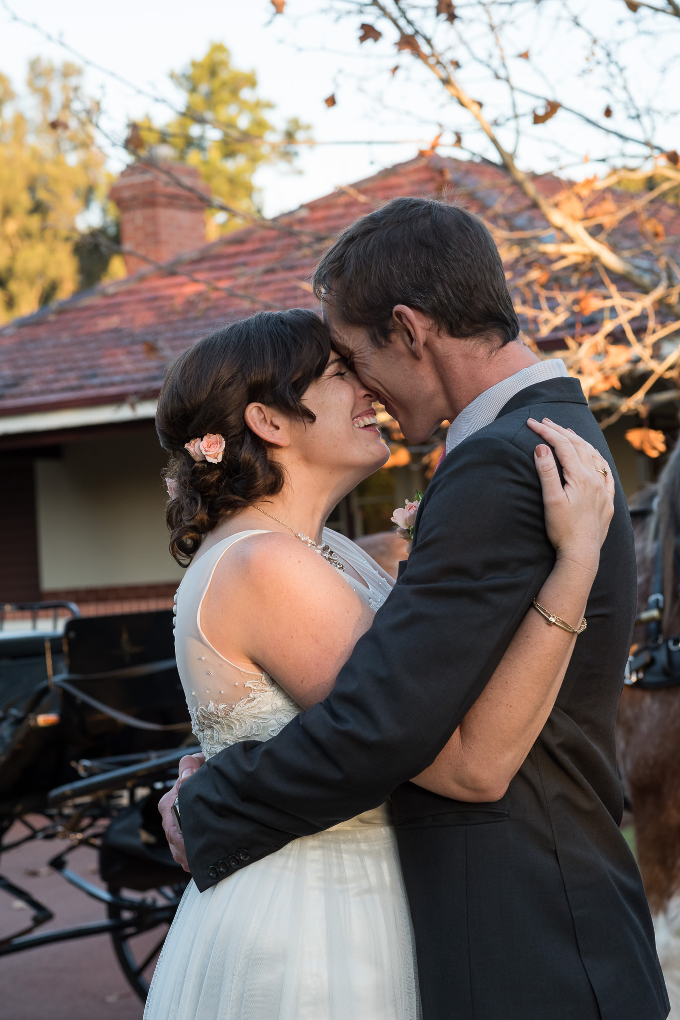 bride and groom press heads together