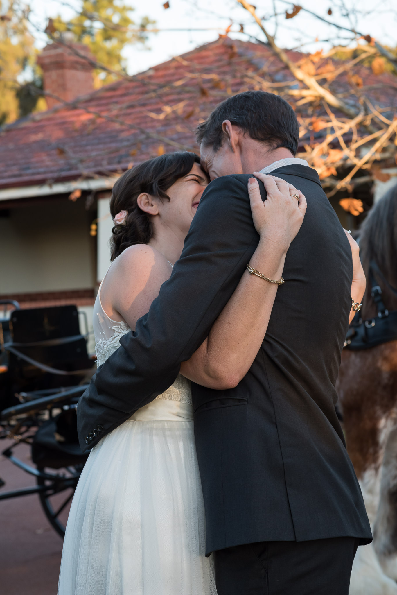 bride and groom hug and swing around