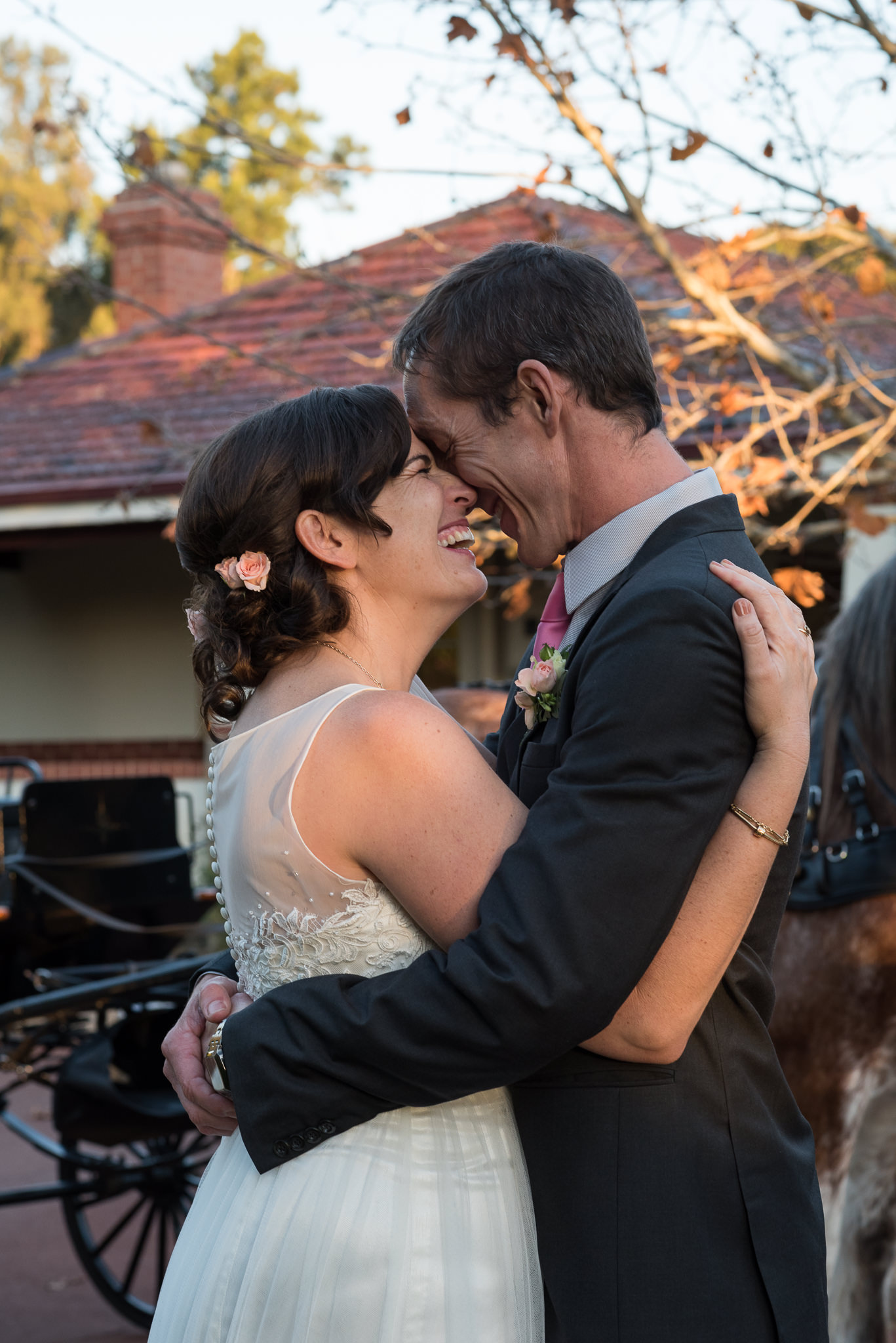 bride and groom laugh together in afternoon light