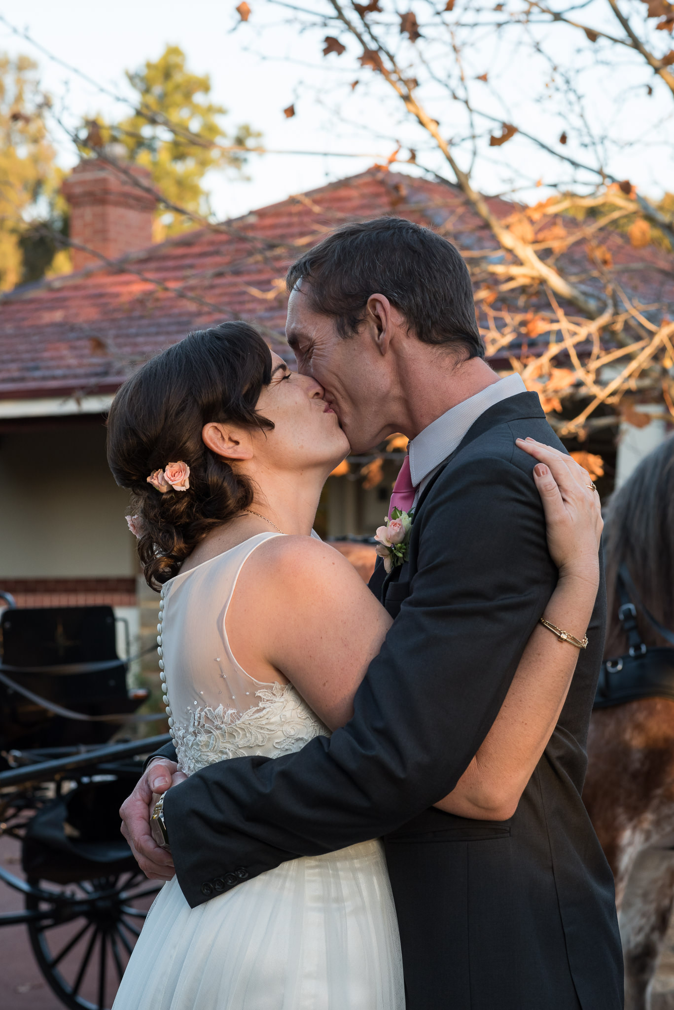 bride and groom kiss in afternoon light