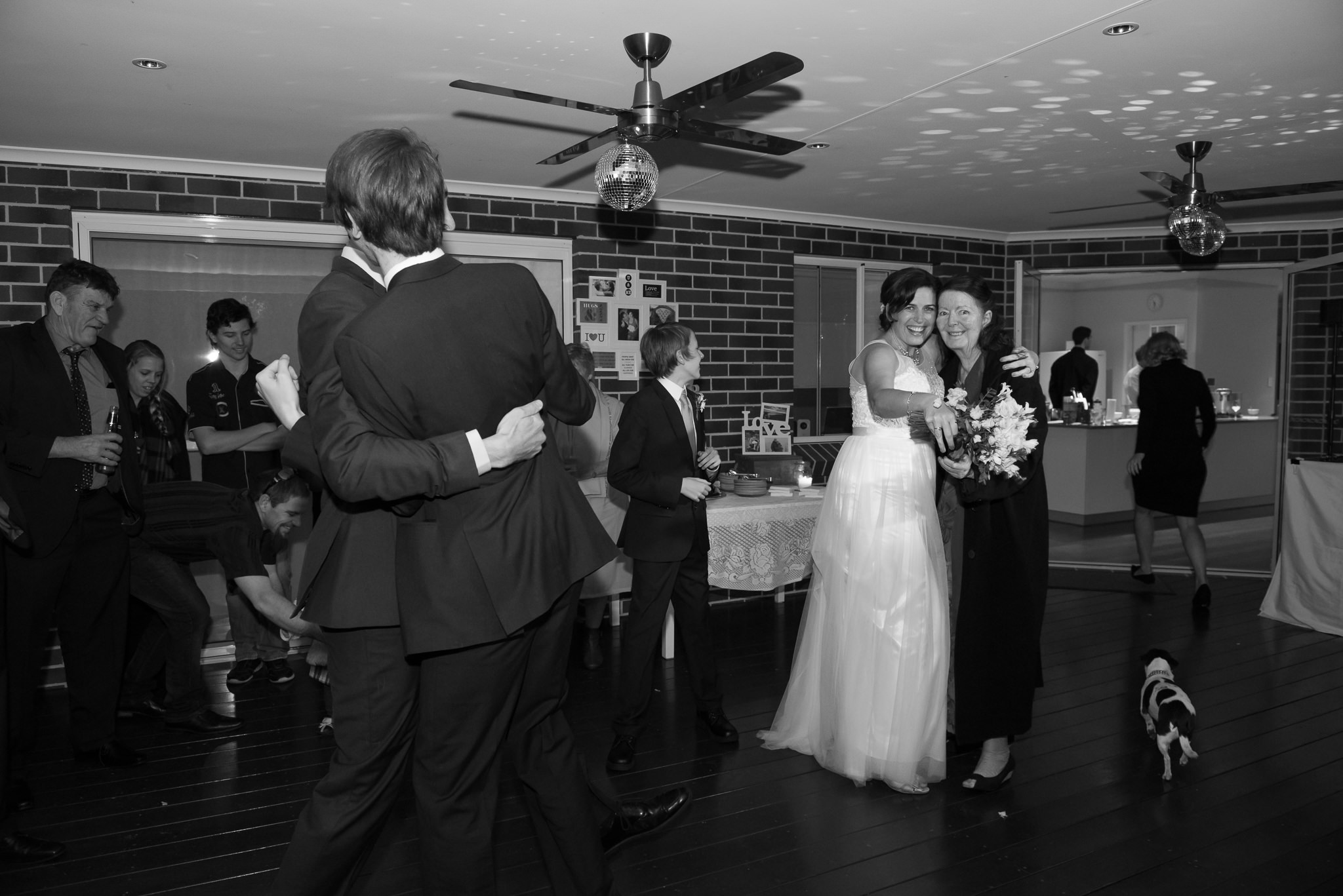 Bride and groom dancing with family on the dance floor