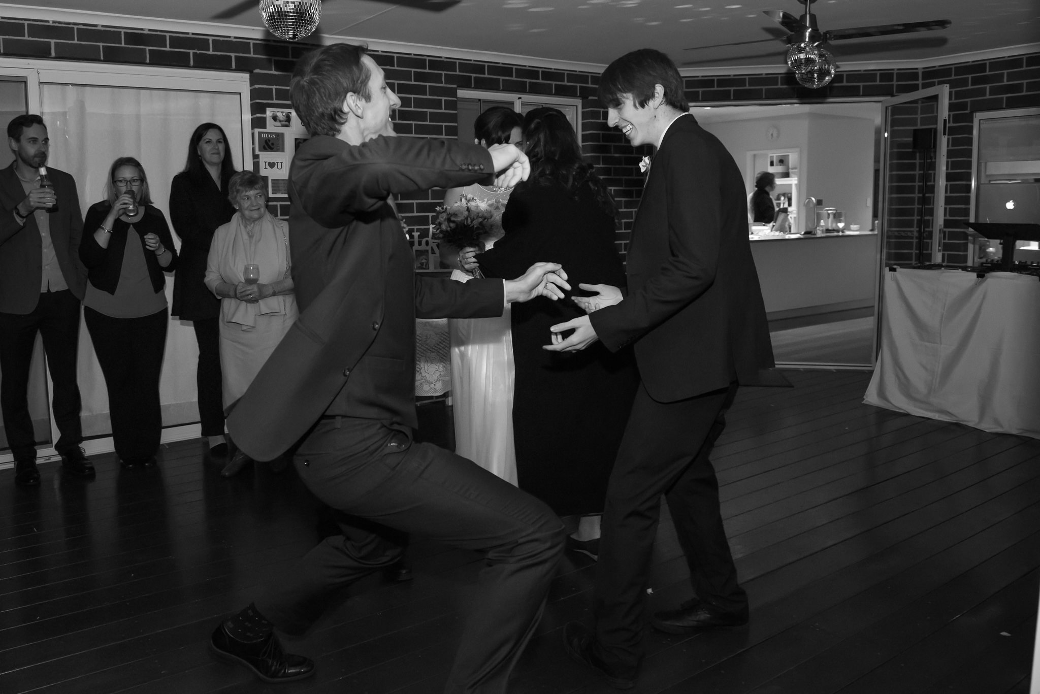 Groom dancing crazily on wedding reception dance floor