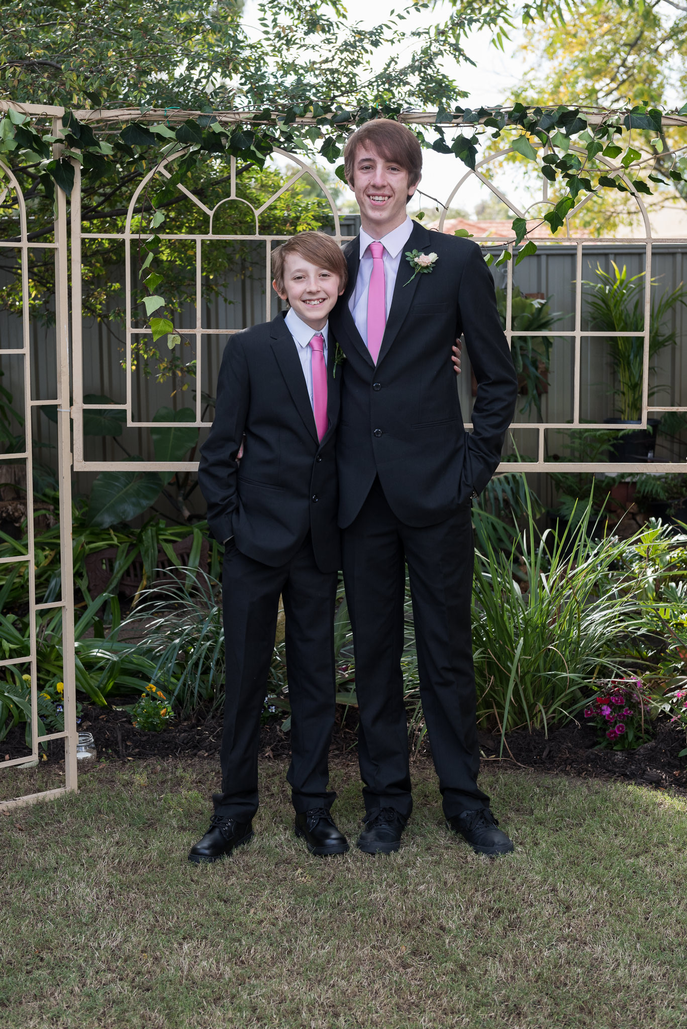 two boys smiling in the backyard wedding ceremony location