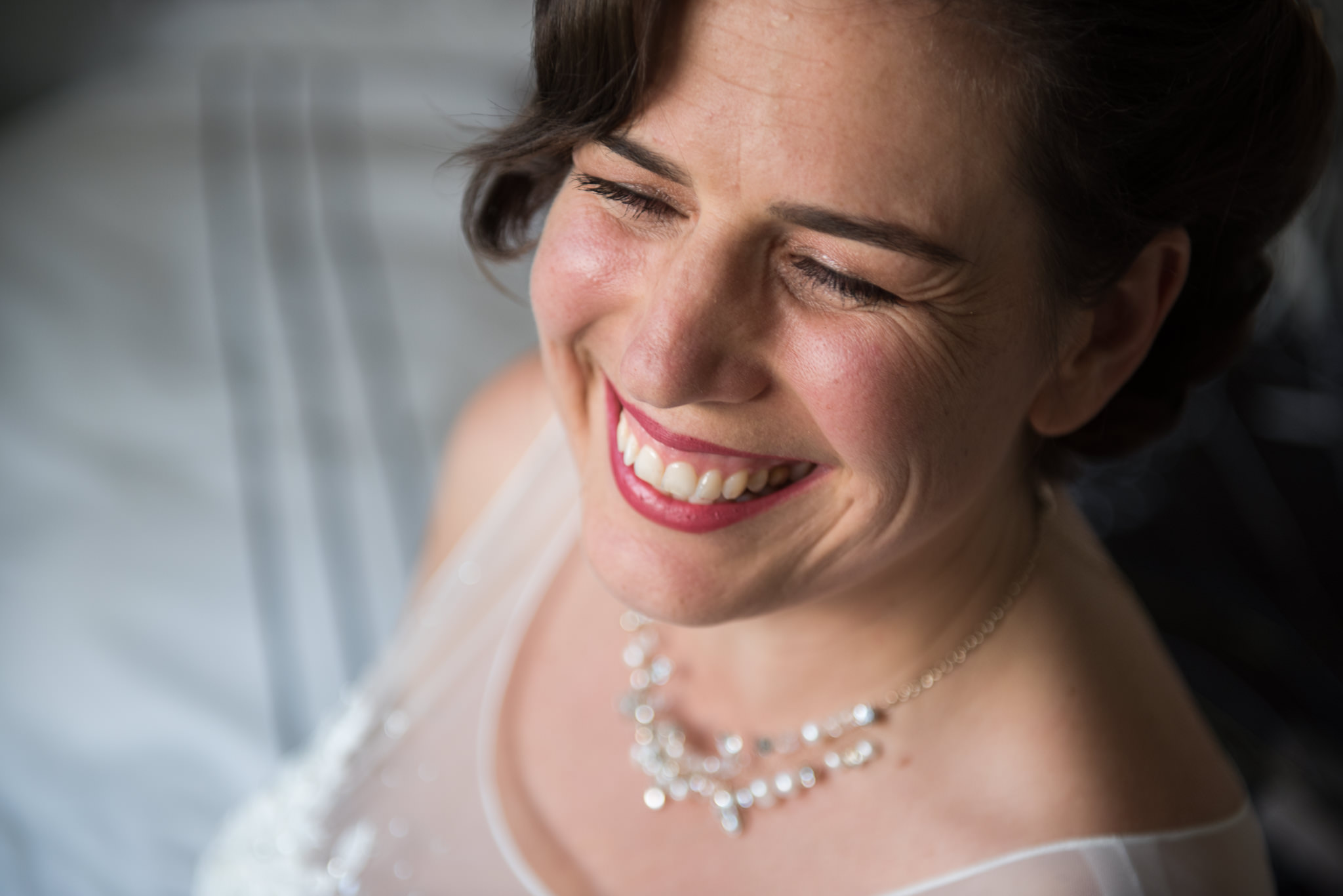 bride smiles with eyes closed