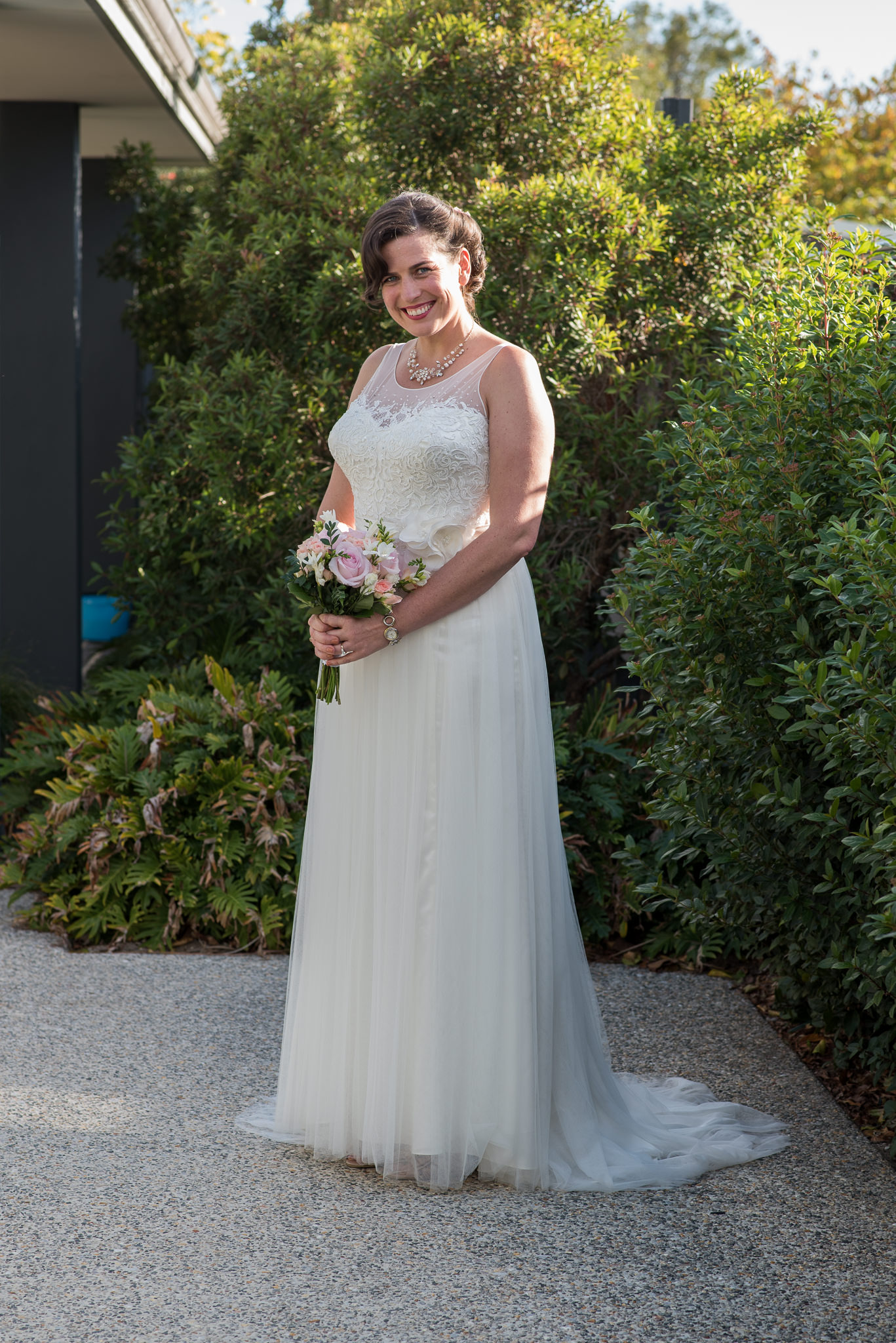 full length bridal portrait holding her bouquet