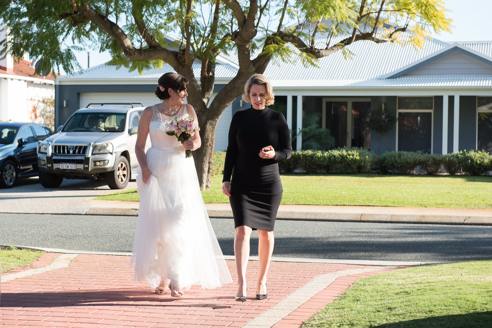 bride walks across the road to her wedding ceremony