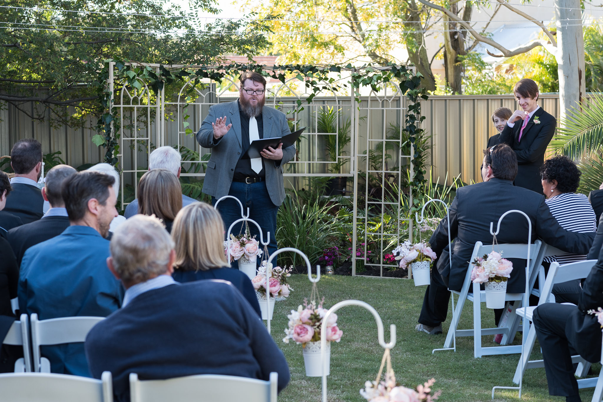 celebrant talks to wedding guests before the ceremony begins