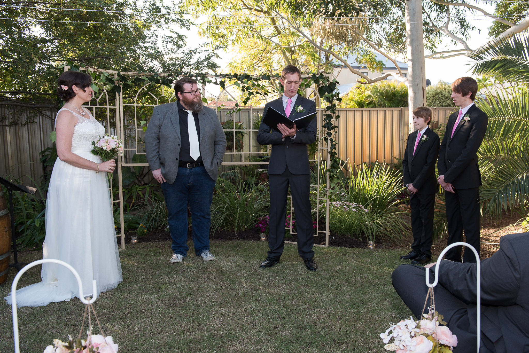 groom saying his vows in backyard