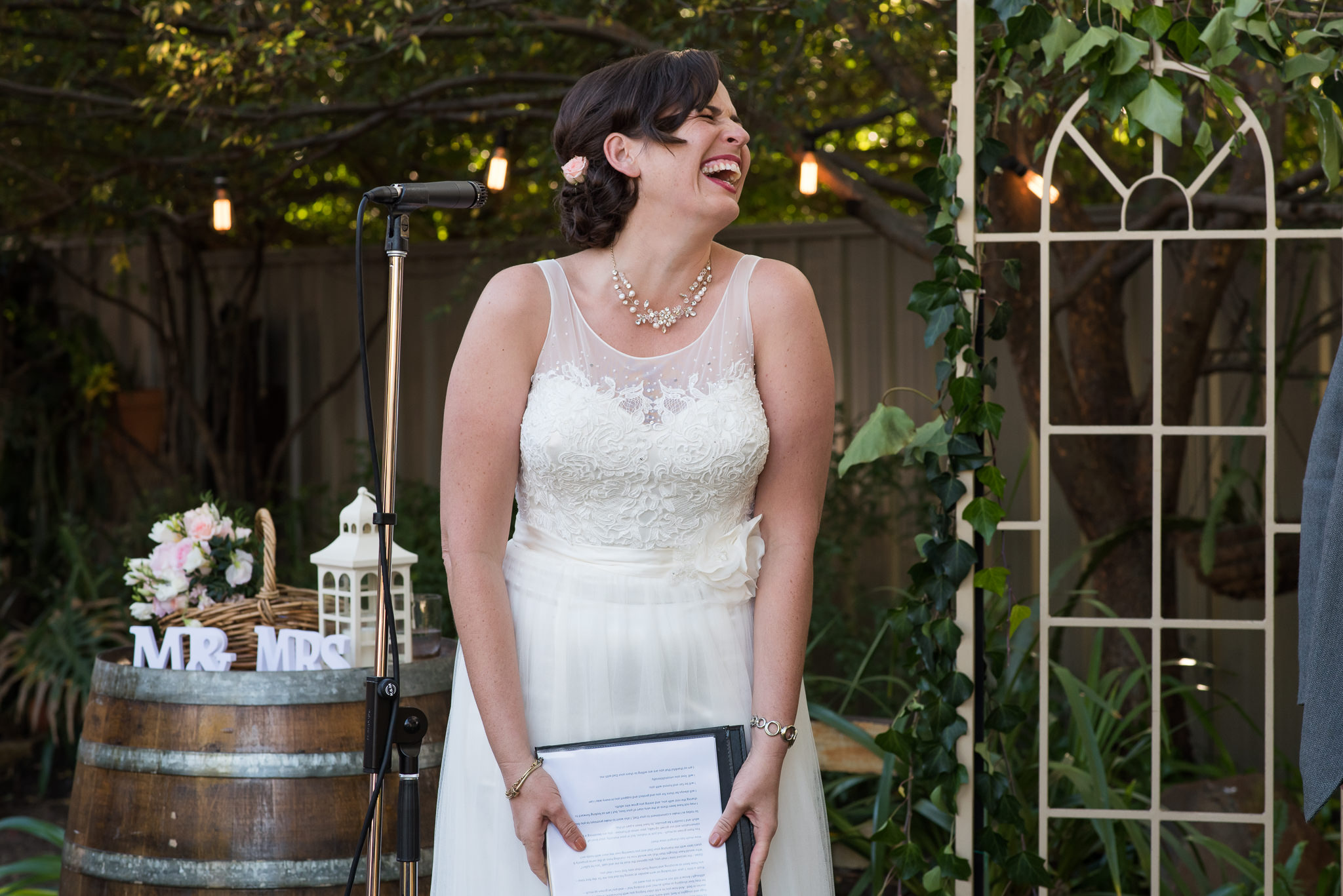 bride laughing during her vows