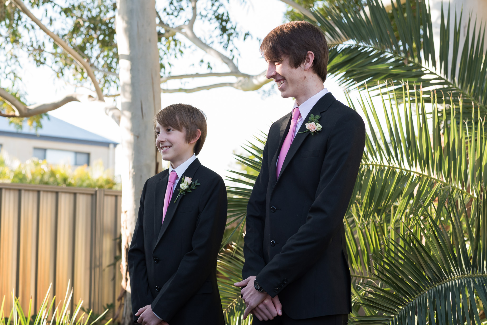 wedding couple's boys smile during ceremony