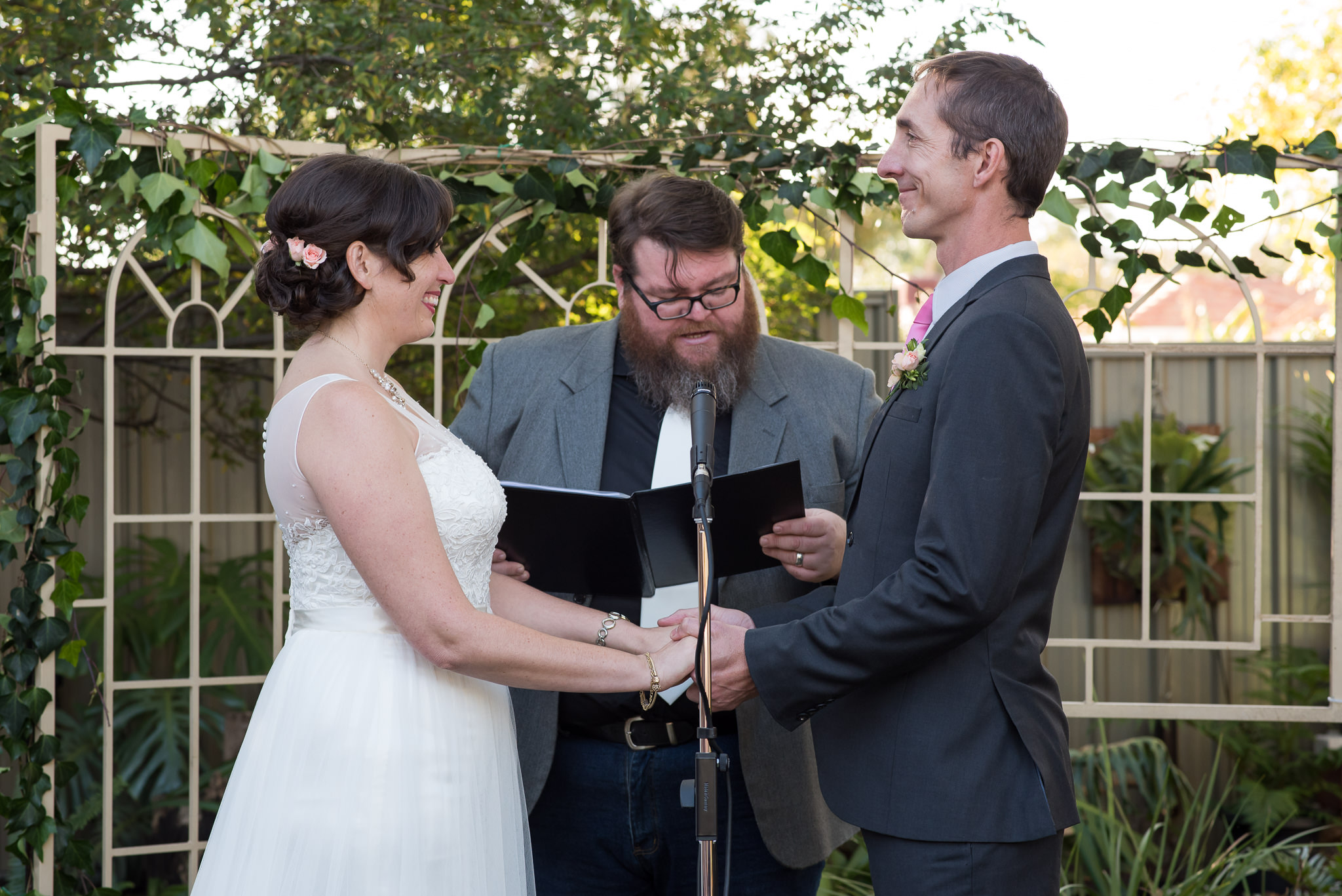 bride and groom smiling during ceremony