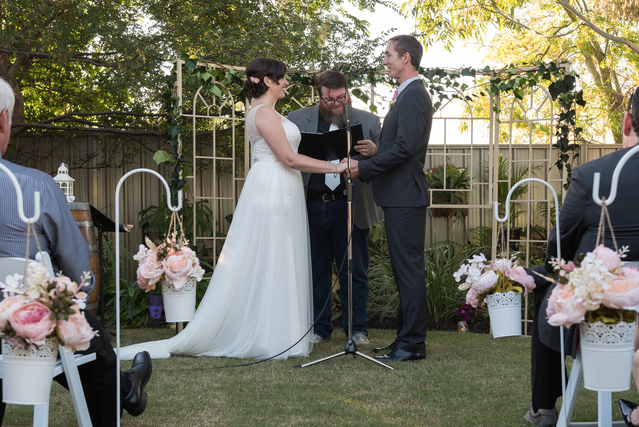 bride and groom holding hands during wedding ceremony