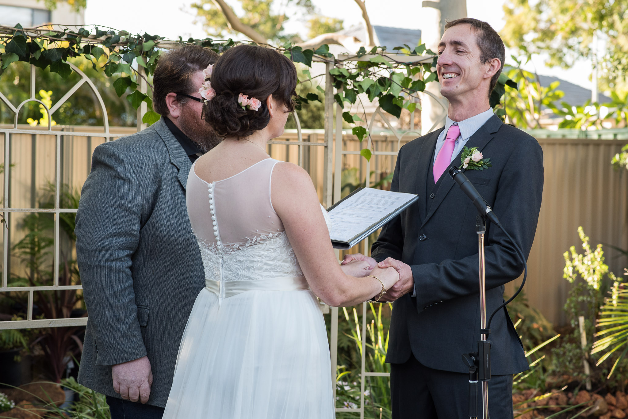 groom grinning during wedding ceremony