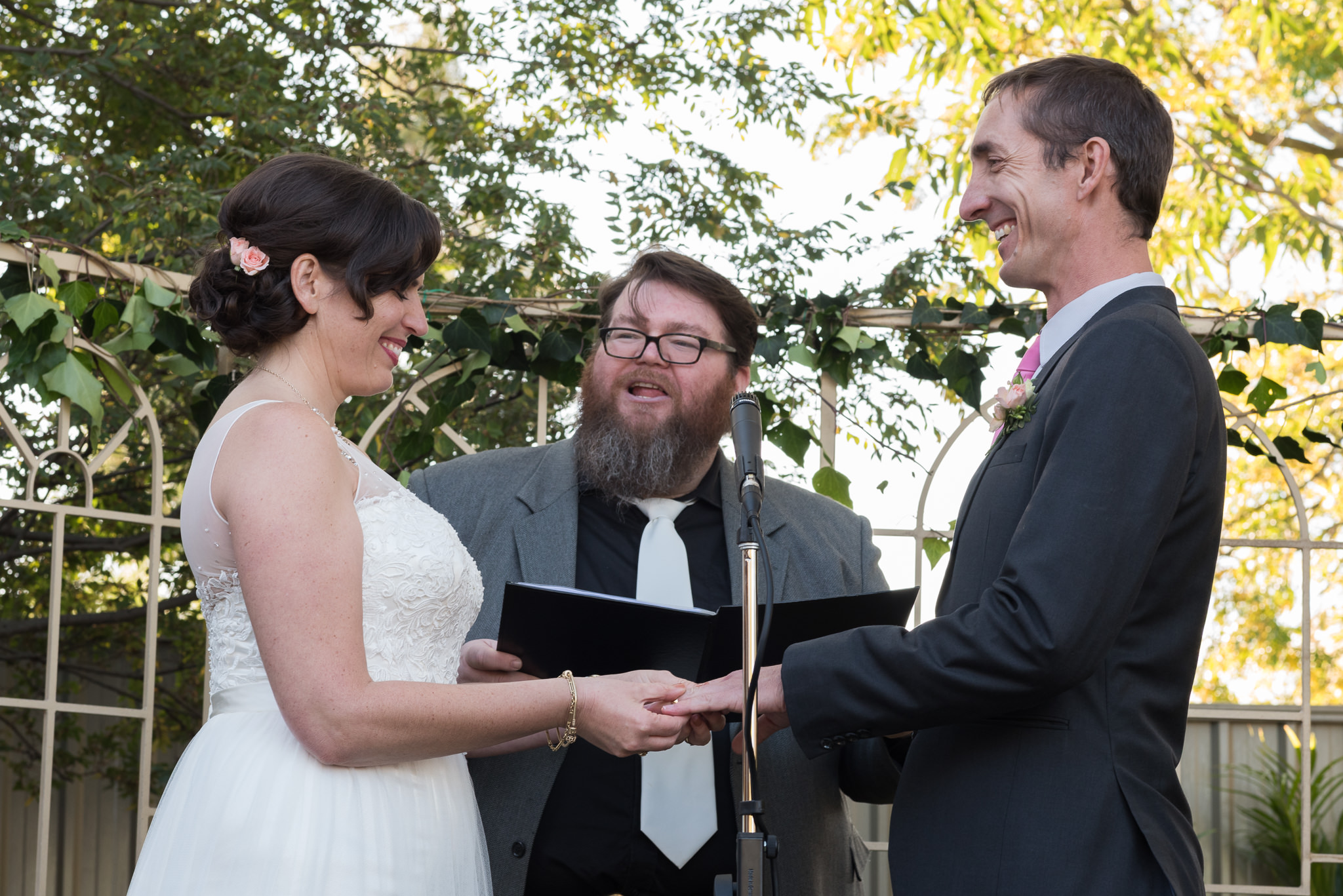 bride and groom smile holding hands