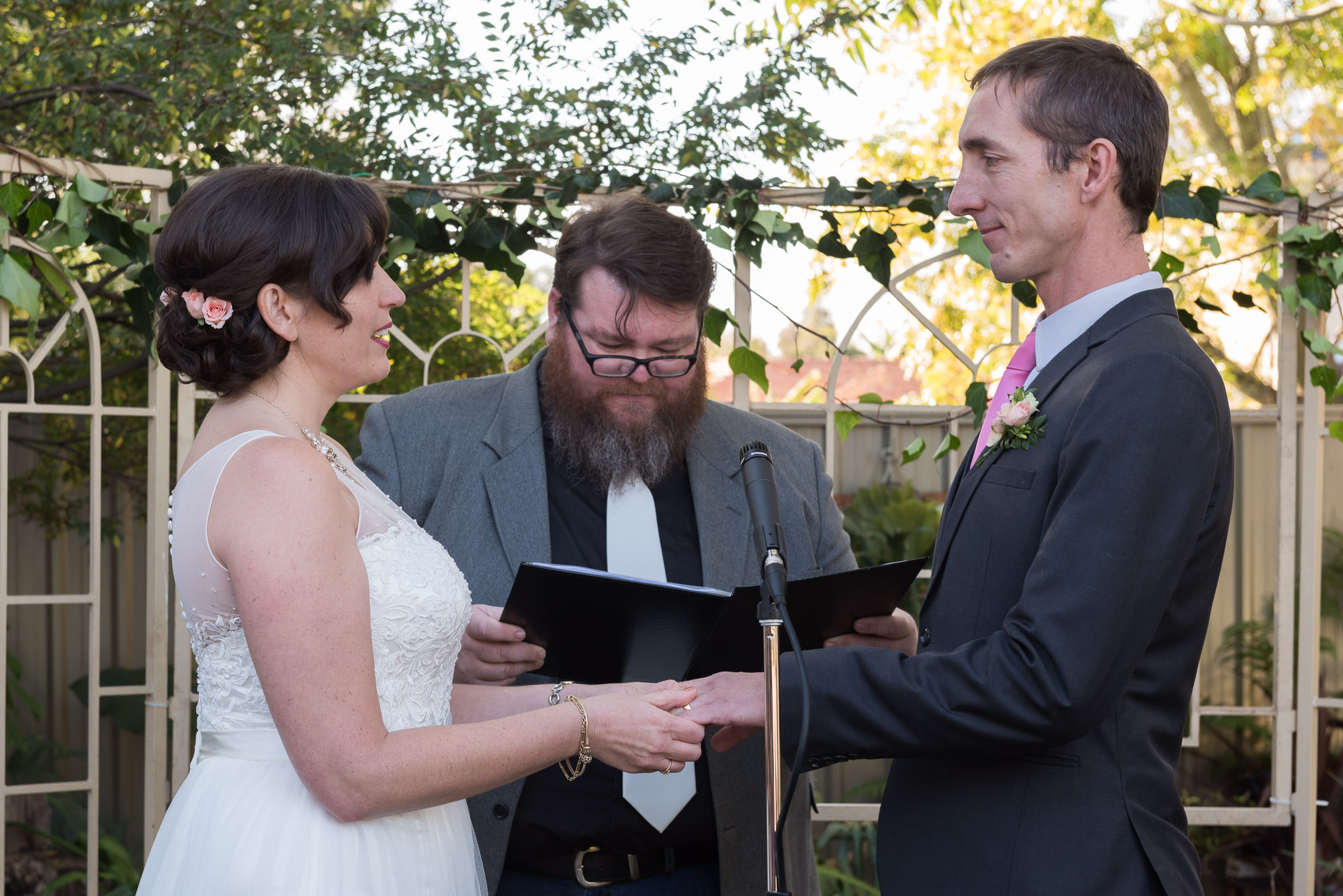 bride and groom says vows in backyard wedding