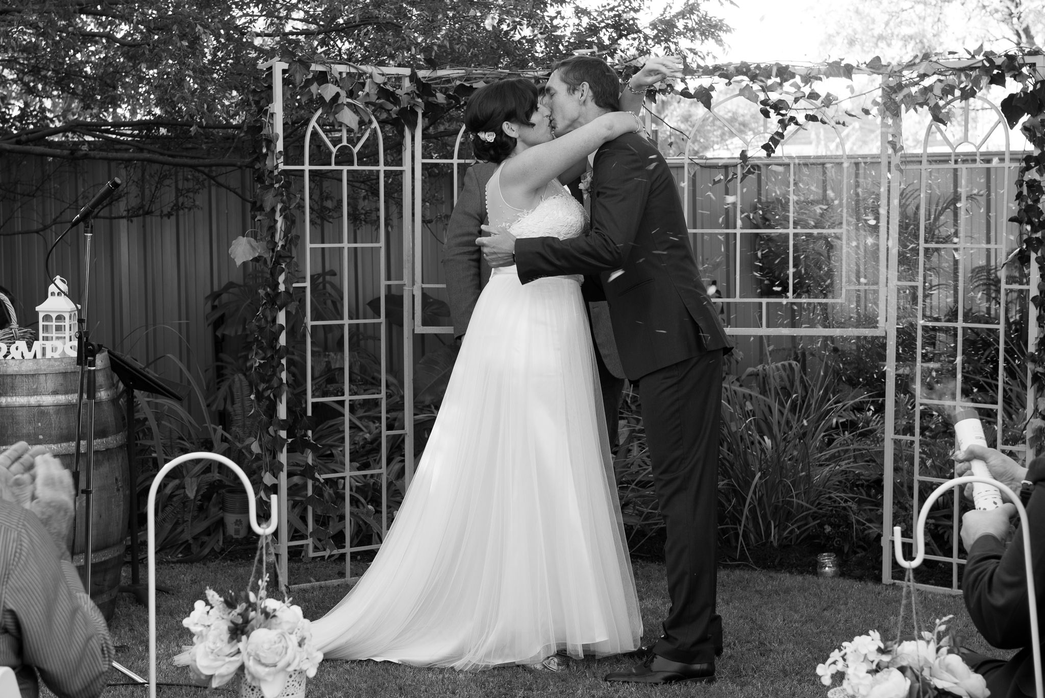 wedding kiss in backyard