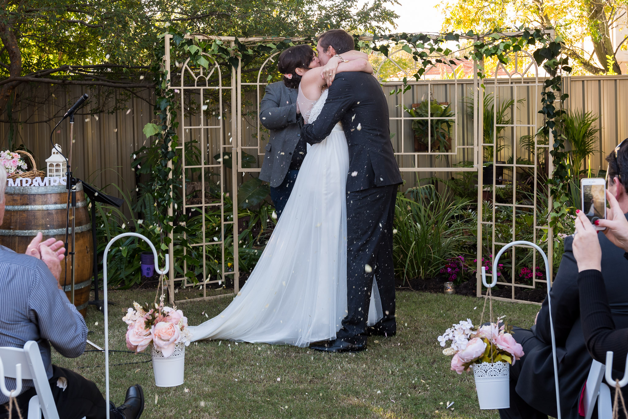 bride and groom kiss after wedding ceremony