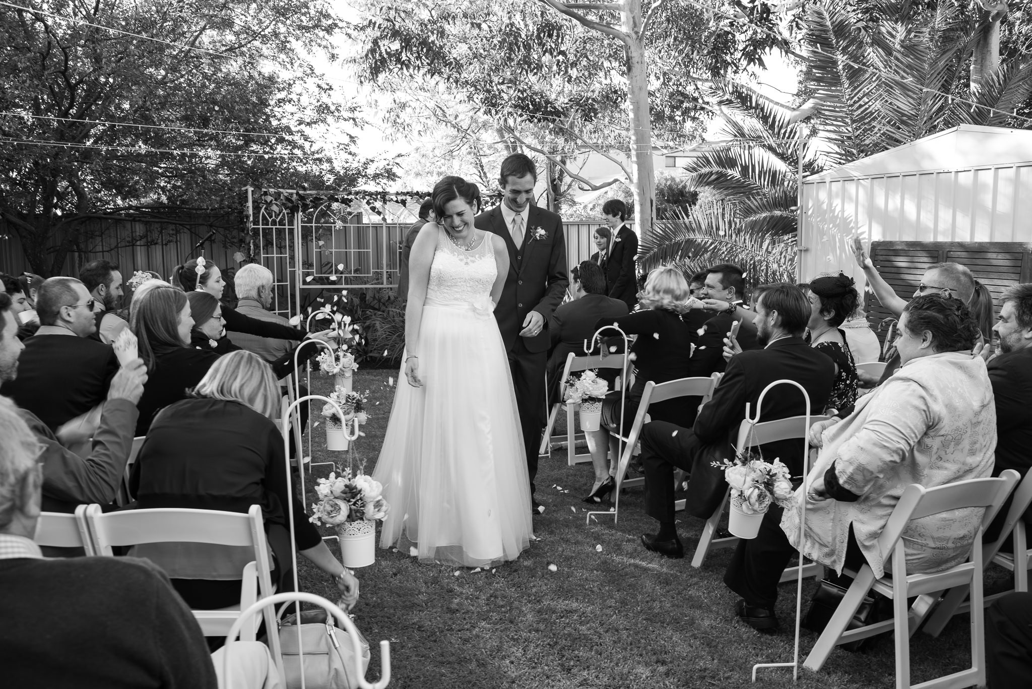 bride and groom have petals thrown over them