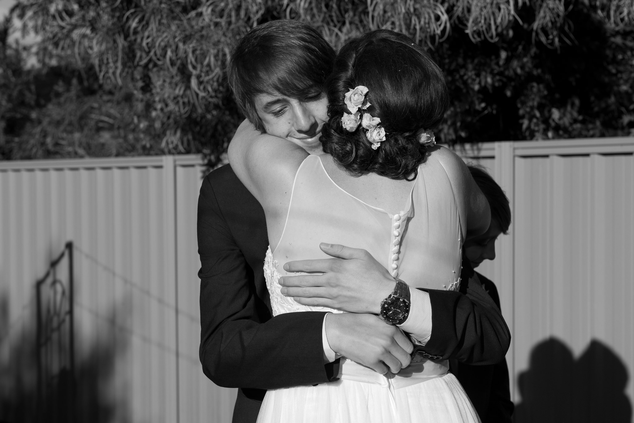 groom's older son hugs the bride