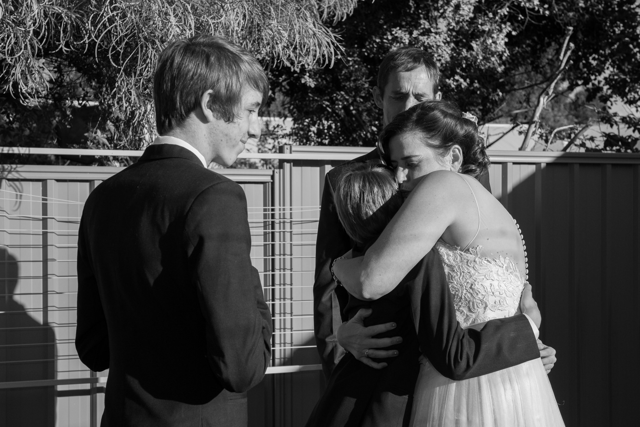 bride hugs her groom's sons