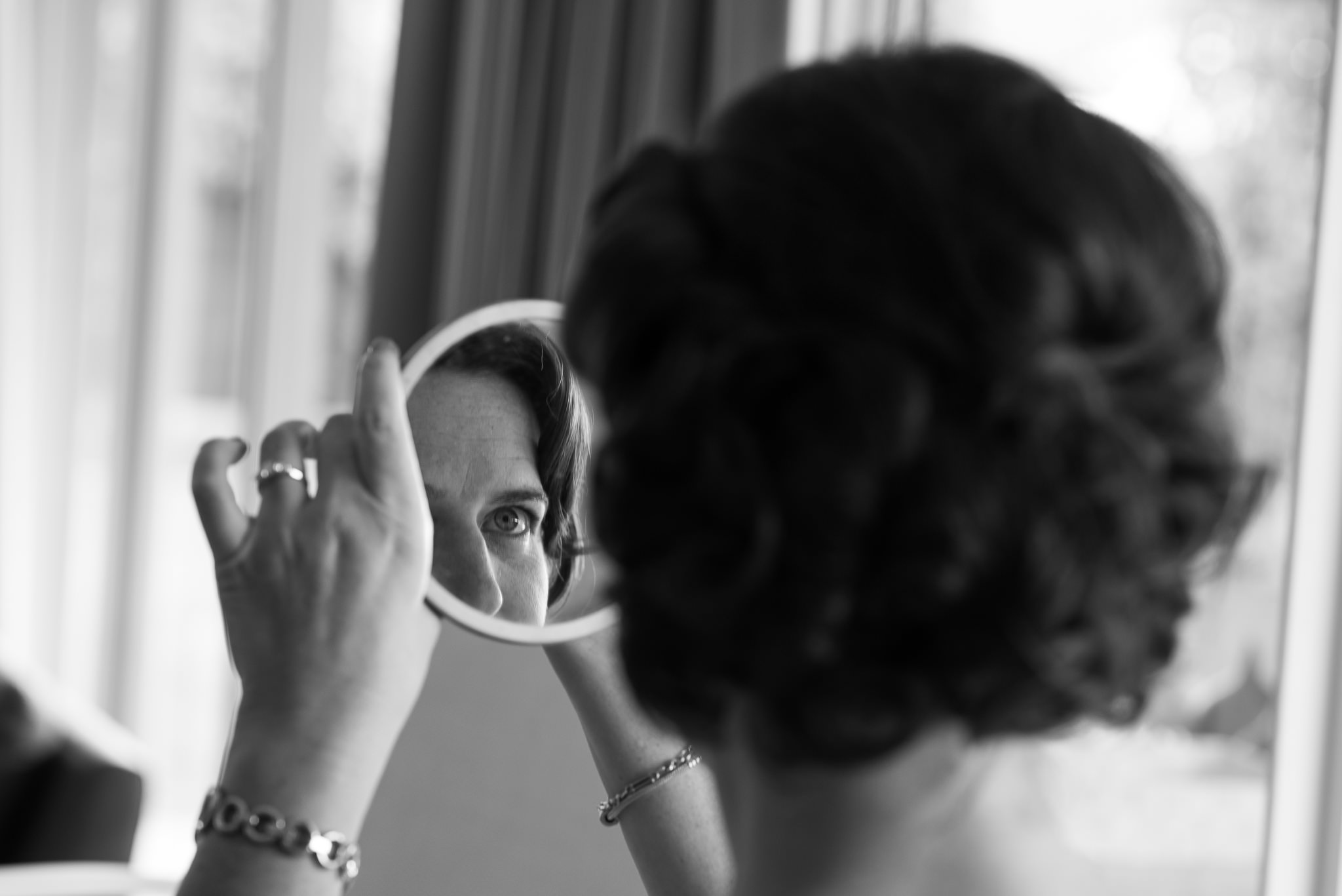 bride looking at herself in a mirror