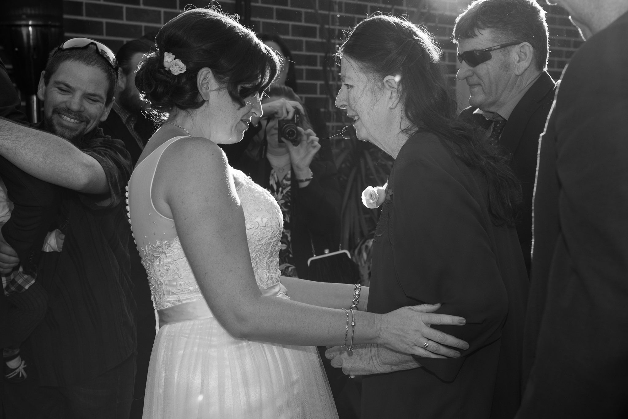 bride's mother hugs her after wedding ceremony