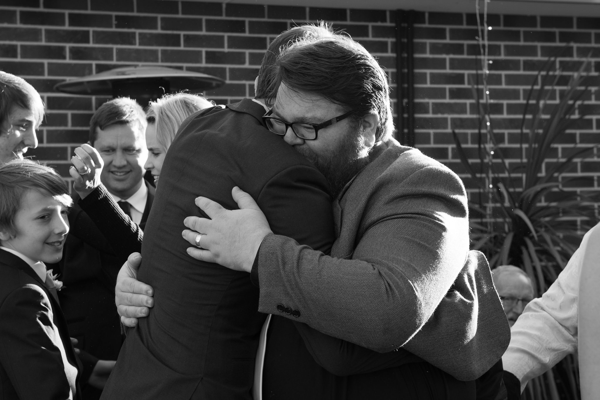 celebrant friend hugs groom