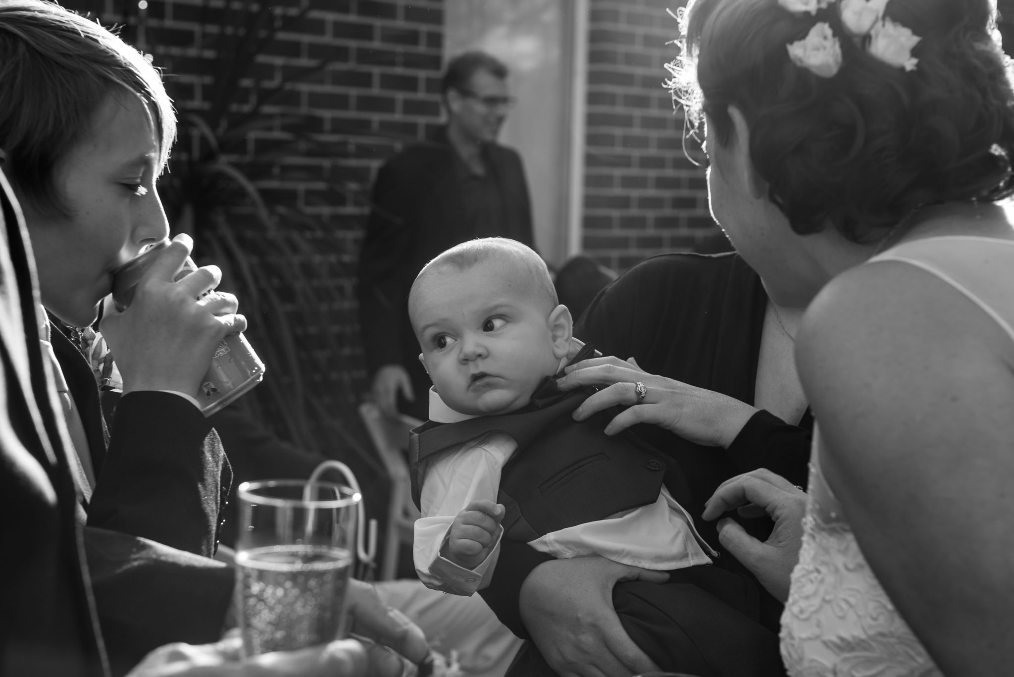 baby at wedding eyes a cold drink