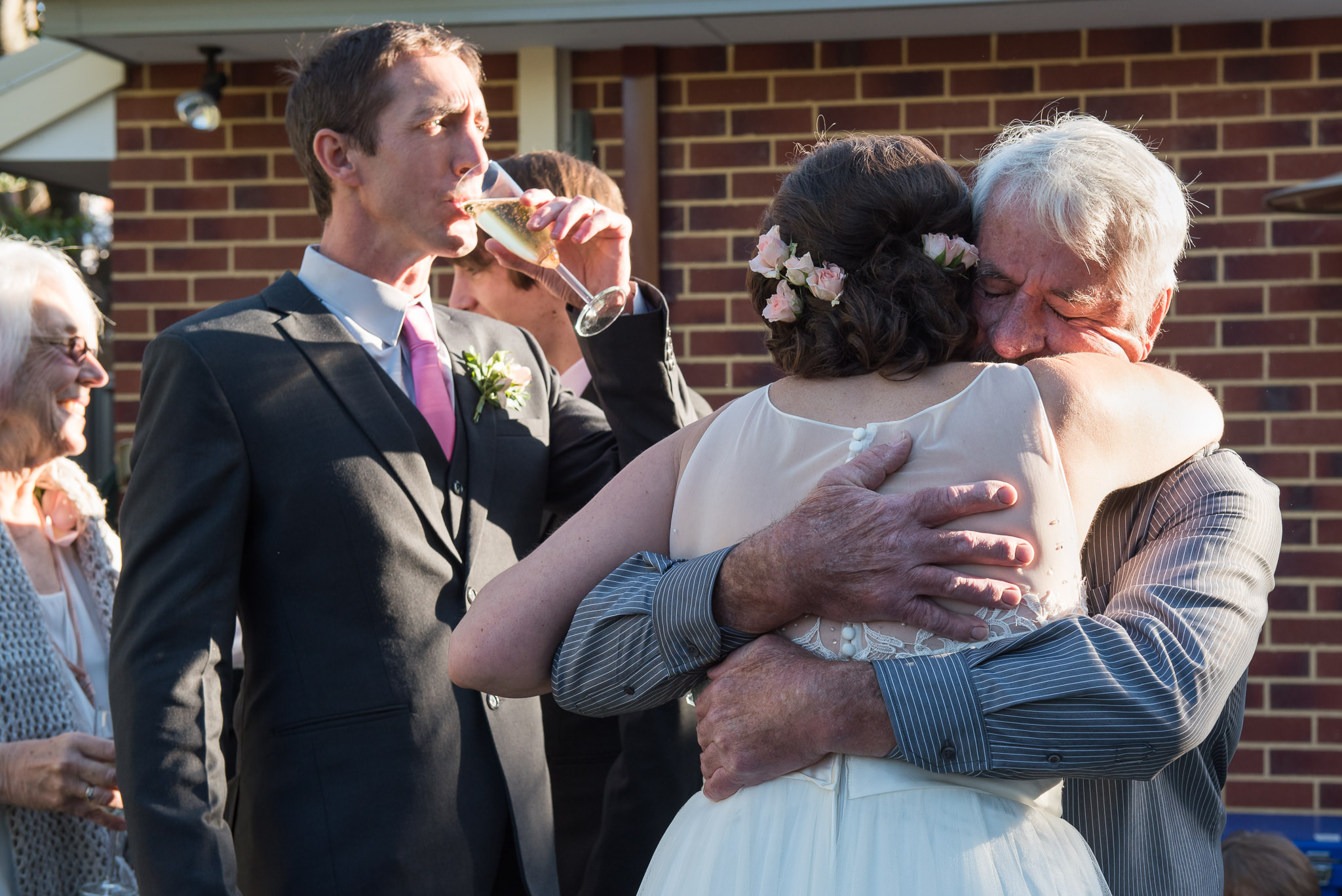 bride's dad hugs her