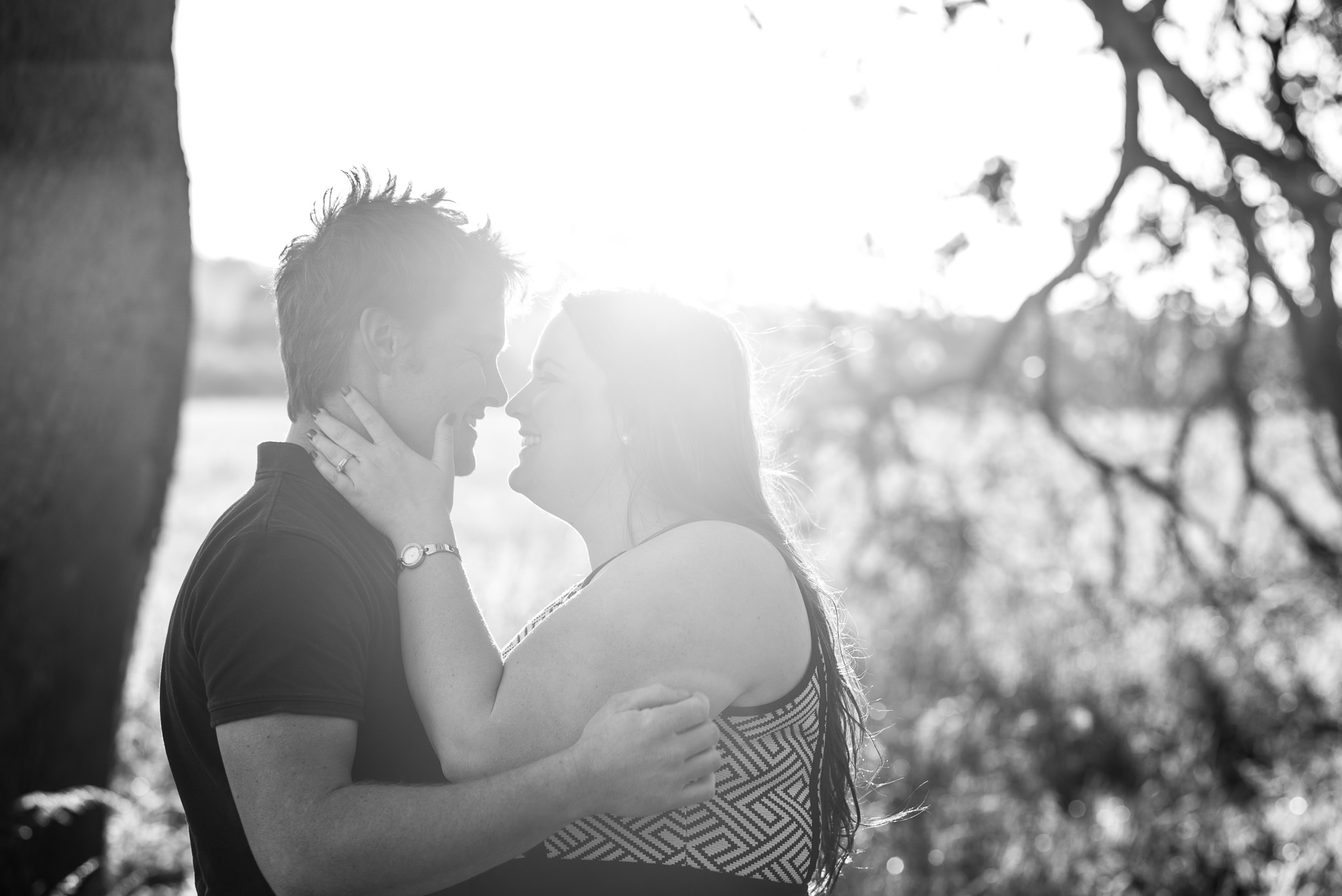 sun flare shot of couple looking at each other