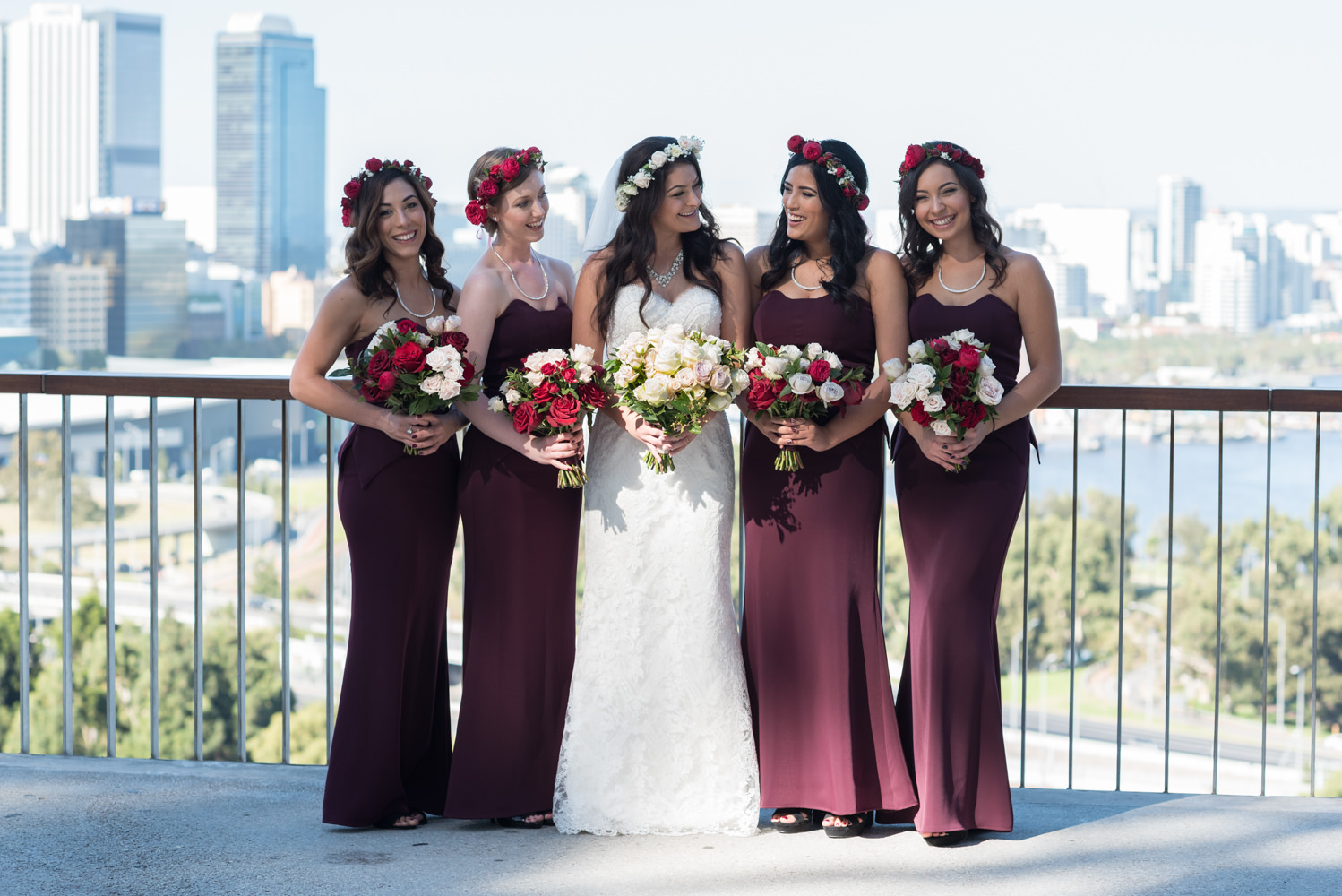 Bride and bridesmaids at King's park with Perth city behind