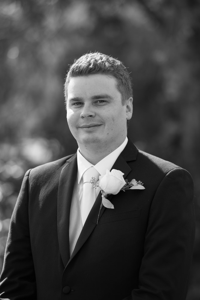 Black and white portrait of the groom