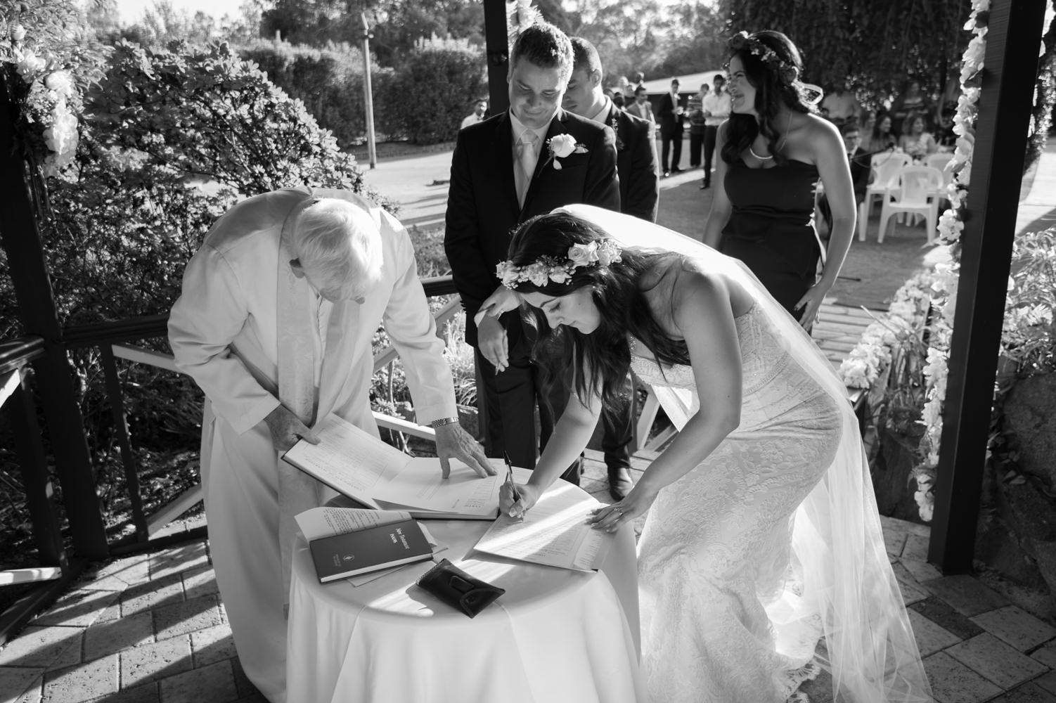 Bride signing the documents after ceremony at Bridgeleigh reception centre