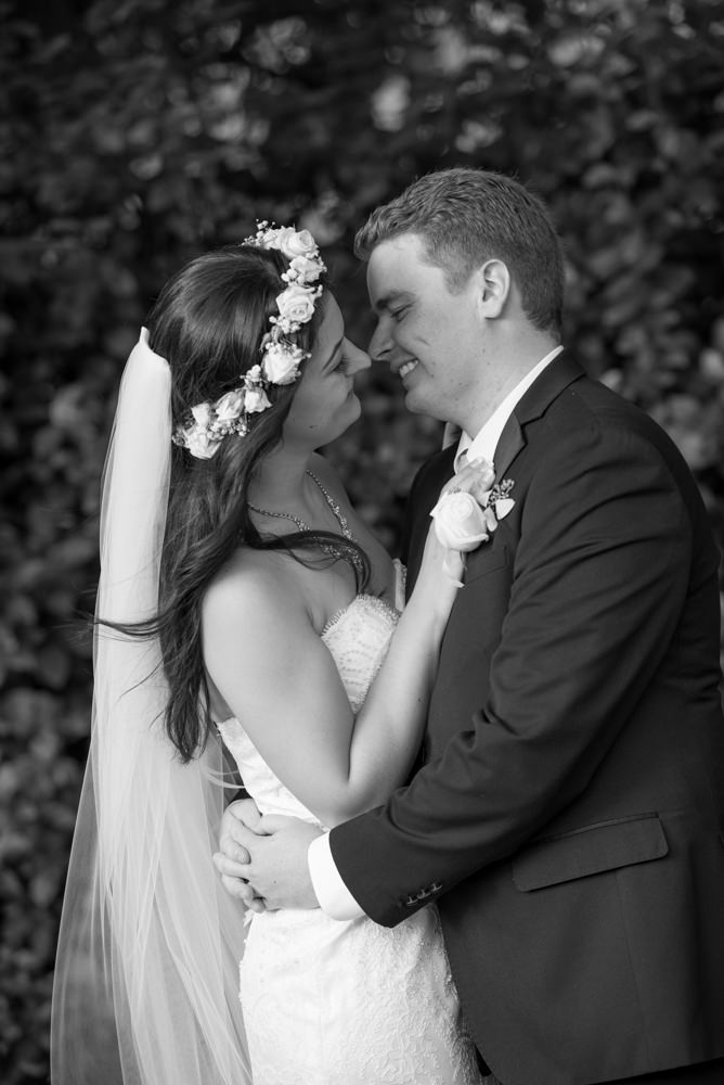 Black and white photo of bride and groom looking at each other