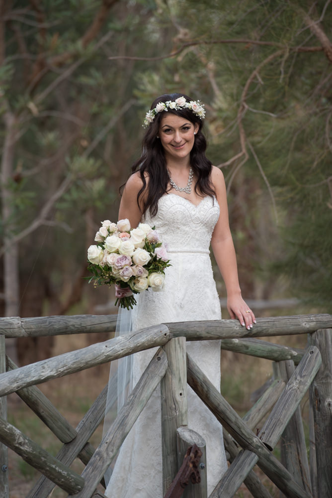 Picture of the bride standing on wooden bridge at Bridgeleigh reception centre