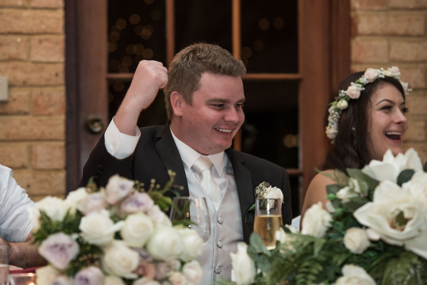 Groom fist pumps the air during speeches