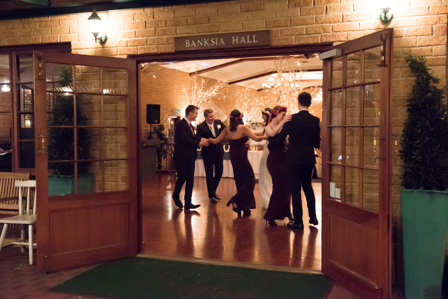 View of the dancing through the doors of the Banksia Hall at Bridgeleigh reception centre