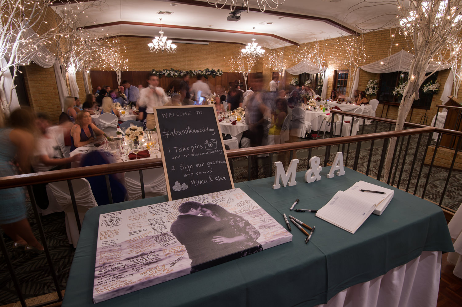 View of wedding gift table with reception in background