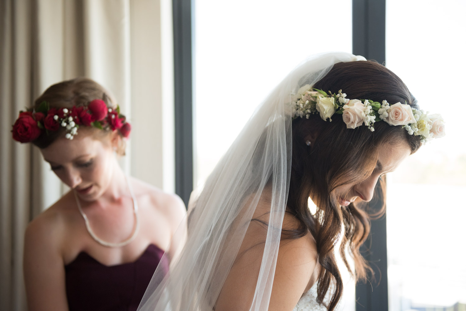 Elegant photo of bride and bridesmaid looking down